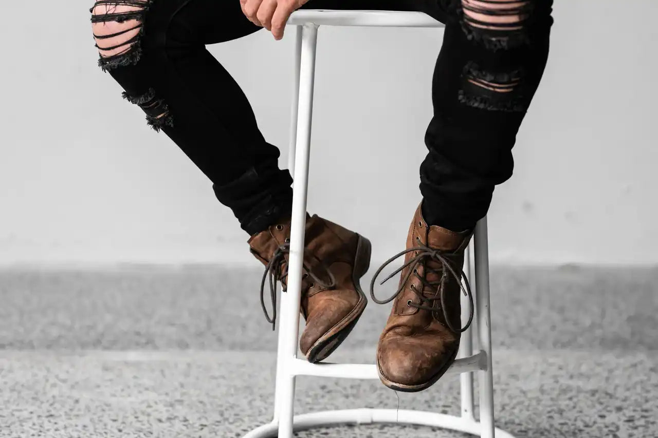 Person sitting on a chair in Melbourne warhorse wearing stitch untitled insight jeans