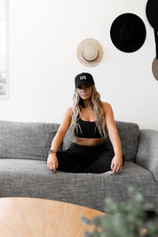 girl wearing stitch untitled midnight cap sitting on a couch in st kilda apartment