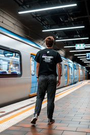 Grace Williams walking through melbourne central station wearing a Pride Cup and Stitch Untitled collaboration tee