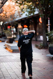 El Chaston walking down Melbourne city street wearing a Pride Cup and Stitch Untitled collaboration tee