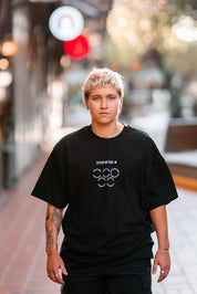 El Chaston walking down Melbourne city street wearing a Pride Cup and Stitch Untitled collaboration tee