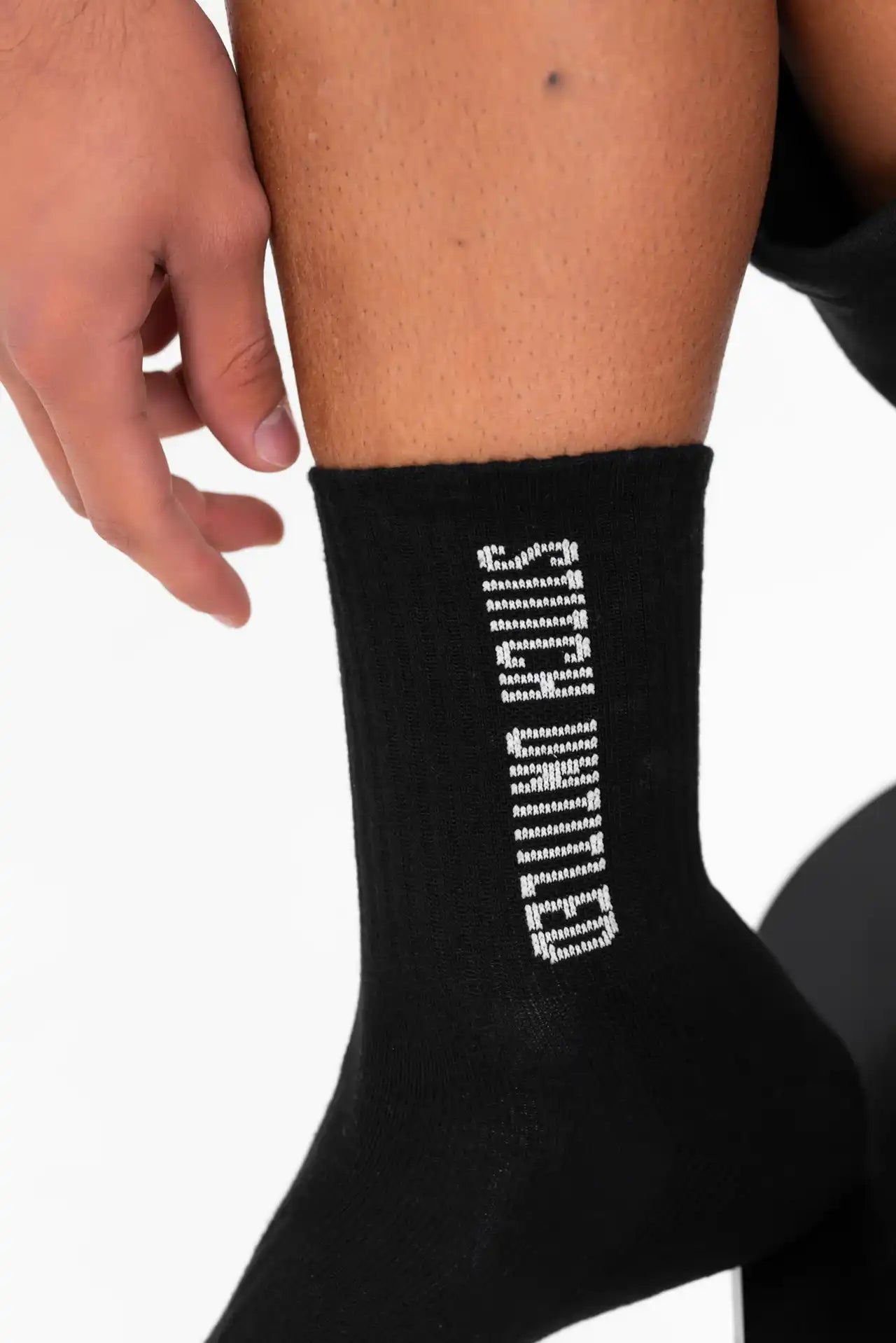 Person sitting in a Melbourne studio wearing stitch untitled socks