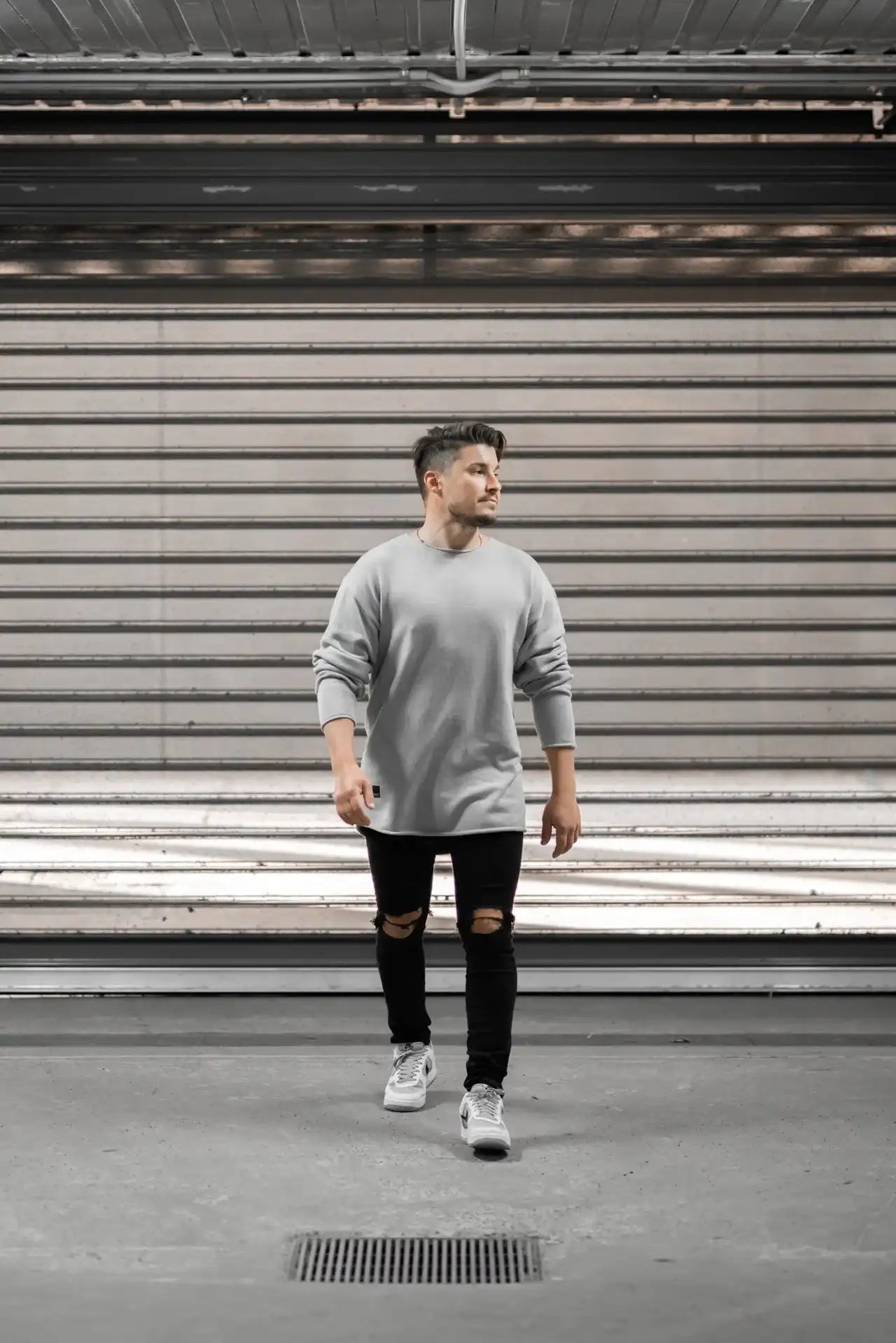 People standing in Melbourne garage wearing stitch untitled grey v1 knit